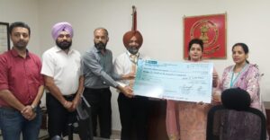 Bank Officials Hand Cheques to Deputy Commissioner.